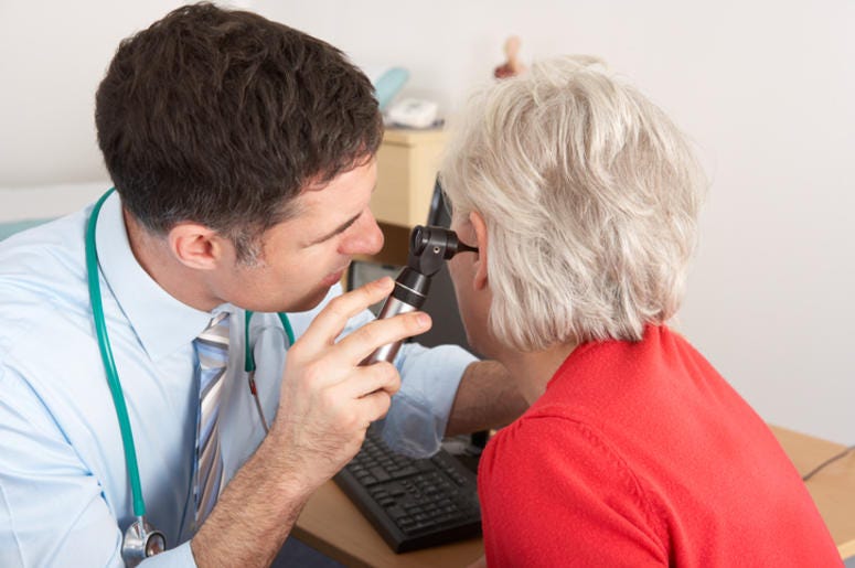 Doctor Looking At A Patients Ear