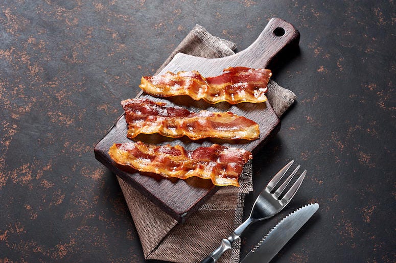 Fried Bacon, Wooden Cutting Board, Fork, Knife Fried Bacon, Wooden Cutting Board, Fork, Knife