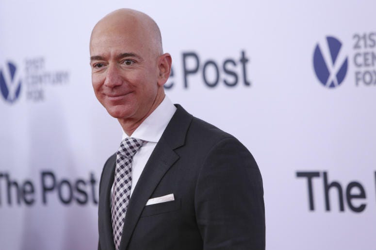 Jeff bezos poses as he arrives on the red carpet for 'The Post' premier at the Newseum Jeff Bezos,Salary,Median,Amazon,10 Seconds,Money,Rich,Executives,CEO,Radio,Employees,100.3 Jack FM