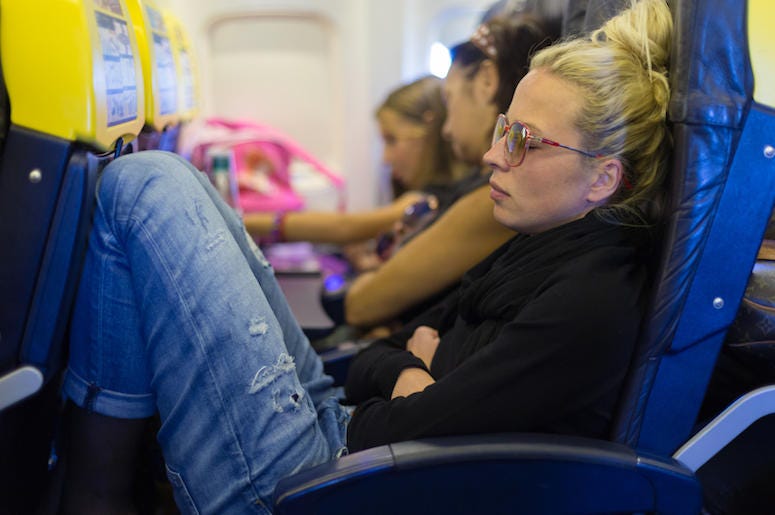 Woman, Napping, Plane, Legroom Woman, Napping, Plane, Legroom