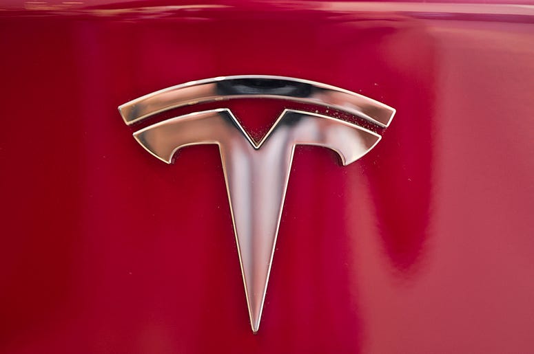 AP18338180922564 This Wednesday, Aug. 8, 2018, file photo shows the Tesla emblem on the back end of a Model S in the Tesla showroom in Santa Monica, Calif. The California Highway Patrol says it may have used the Autopilot system of a Tesla Model S to stop the car after it
