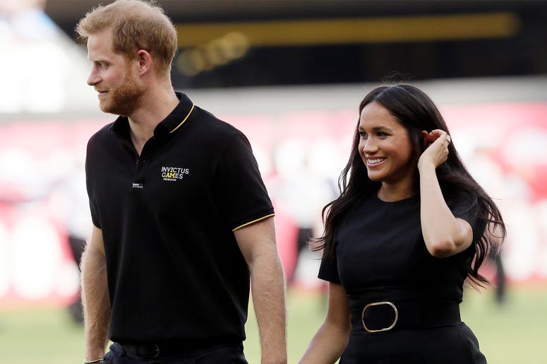 AP19249548736961 In this Saturday, June 29, 2019 file photo, Britain's Prince Harry, left, and Meghan, Duchess of Sussex, walk off the field before a baseball game in London. (AP Photo/Tim Ireland, file)