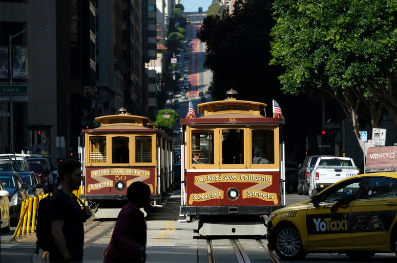 AP19254689092171 A cable car at right begins to make its way up California Street Wednesday, Sept. 11, 2019, in San Francisco. (AP Photo/Eric Risberg)
