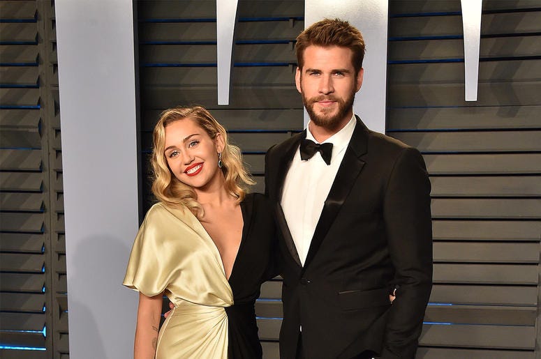 Miley Cyrus and Liam Hemsworth BEVERLY HILLS, CA - MARCH 4: Miley Cyrus (L) and actor Liam Hemsworth arrives at the 2018 Vanity Fair Oscar Party at the Wallis Annenberg Center for the Performing Arts on March 4, 2018 in Beverly Hills, California.(Photo by Scott Kirkland/PictureGroup/Si