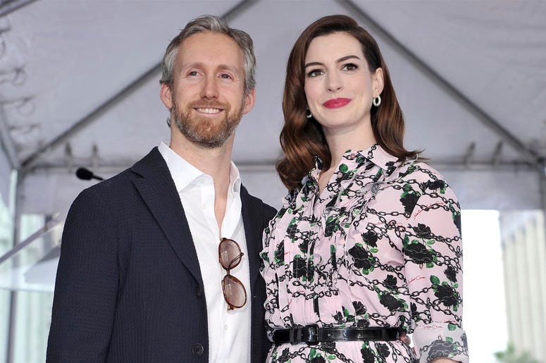 AP19205688513620 This May 9, 2019 file photo shows actress Anne Hathaway, right, and her husband Adam Shulman at a ceremony honoring Hathaway with a star on the Hollywood Walk of Fame in Los Angeles. (Photo by Richard Shotwell/Invision/AP, File)