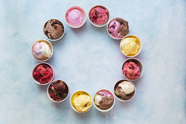 (Sstajic/iStock/Getty Images Plus) Different cups of ice cream flavors set in circle shape on rustic background