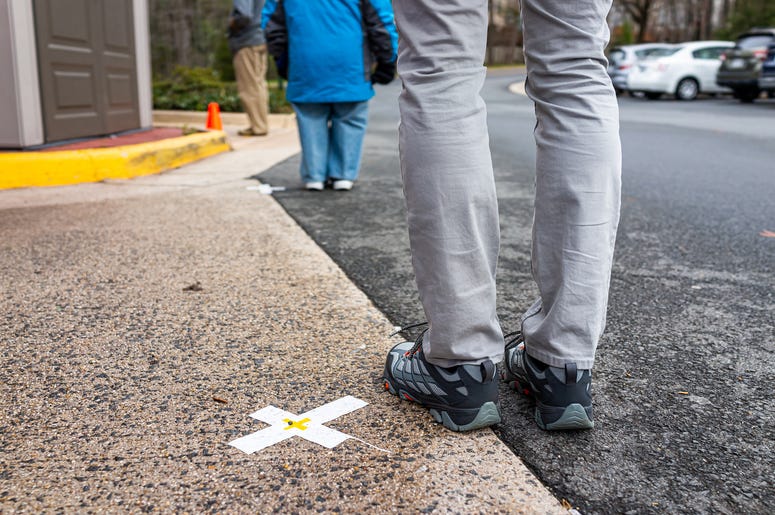 (krblohkin/ iStock/ Getty Images Plus) People standing waiting in line far apart to maintain social distance distancing during covid-19 coronavirus outbreak with mark cross signs on sidewalk pavement by grocery food store shop shopping
