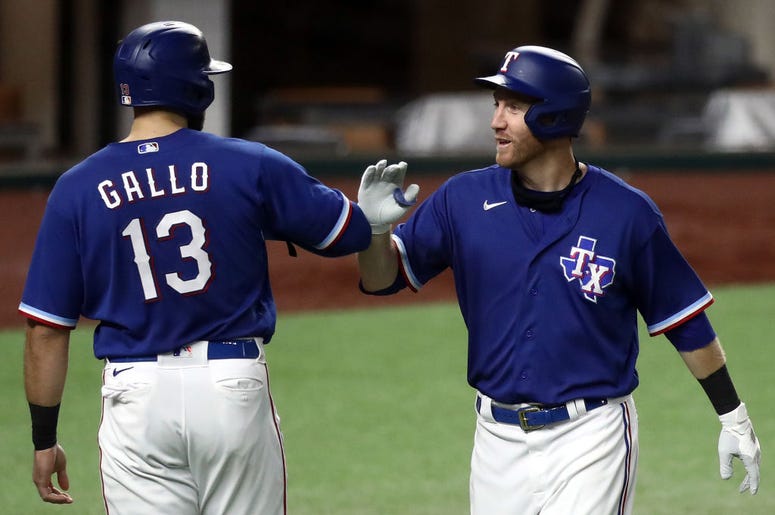 (Ronald Martinez/ Getty Images) Texas Rangers players celebrate during an exhibition game.