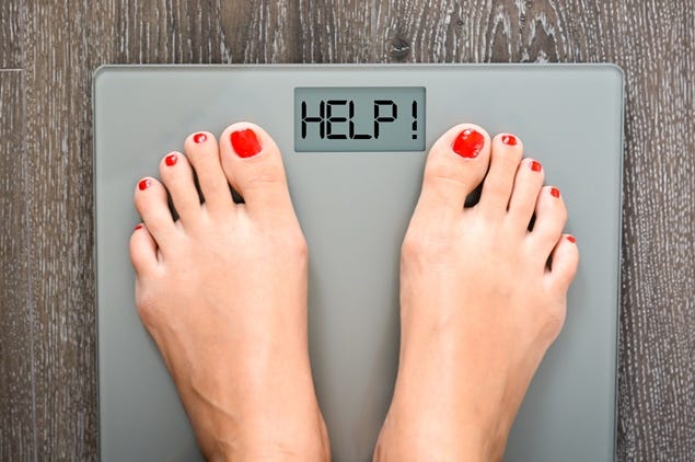 Lose weight concept with person on a scale measuring kilograms Lose weight concept with person on a scale measuring kilograms