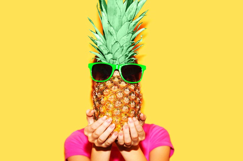 Getty Images Fashion portrait woman and pineapple with sunglasses over colorful yellow