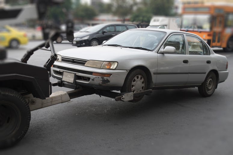 (kayasit/ iStock/ Getty Images Plus) Car being towed by tow truck