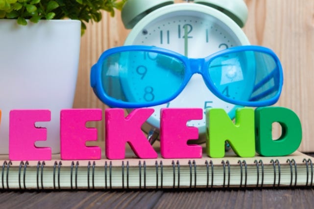 WEEKEND letters text and notebook paper, alarm clock and little WEEKEND letters text and notebook paper, alarm clock and little