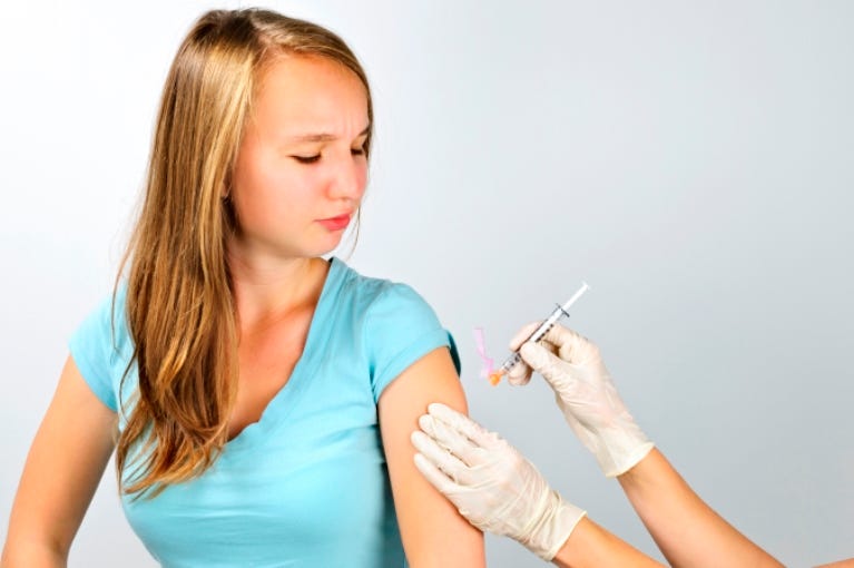 Girl getting flu shot Girl getting flu shot