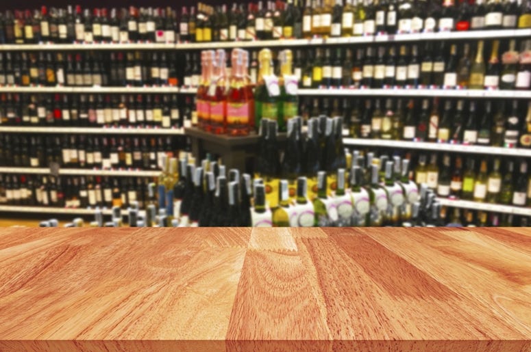 Wood table and wine Liquor bottle on shelf blurred background. Label, display. Wood table and wine Liquor bottle on shelf blurred background. Label, display.