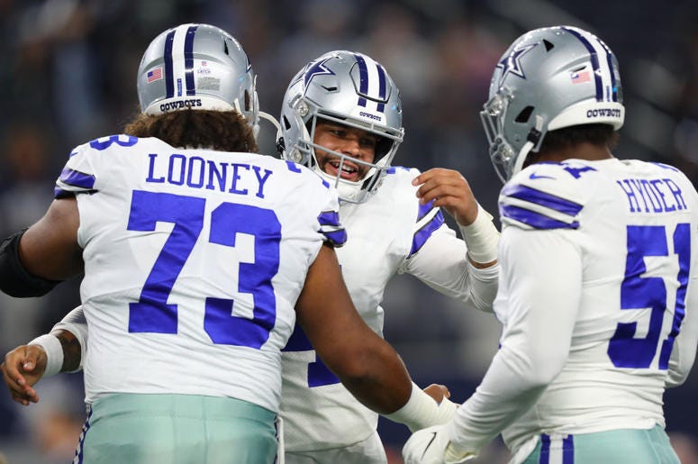 (Tom Pennington/ Getty Images) Dak Prescott and Joe Looney hug before Dallas Cowboys game