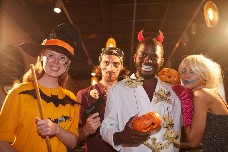 (SeventyFour/ iStock/ Getty Images Plus) People wearing Halloween costumes posing as witches and pirates