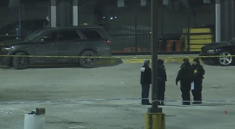 Police officers stand outside in bitter cold at the site of a deadly shooting outside the 9ine Ultra Lounge in the Kansas City area.