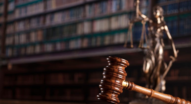 Photograph of judge's gavel and statuette of blindfolded lady justice