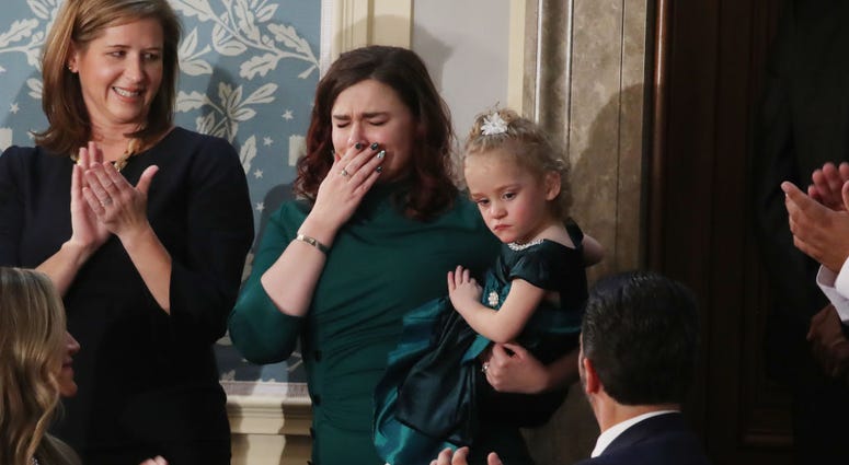 Two-year-old Ellie Schneider is held by her mother, Robin, at the State of the Union Address in the US House Chamber. Two-year-old Ellie Schneider is held by her mother, Robin, at the State of the Union Address in the US House Chamber.