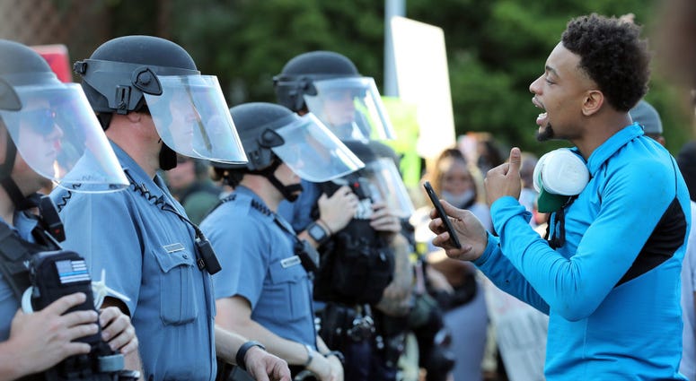 A demonstrator yells at police officers during a protest on May 31, 2020 in Kansas City, Missouri. Protests erupted around the country in response to the death of George Floyd in Minneapolis, Minnesota while in police custody.