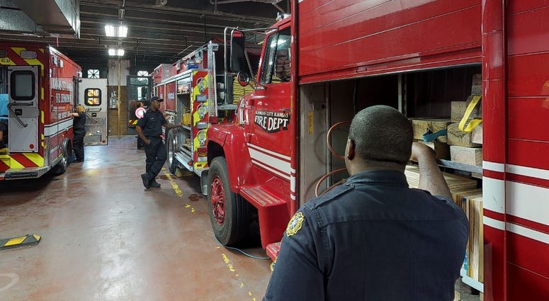 Firefighters standing inside station in Kansas City, Kansas