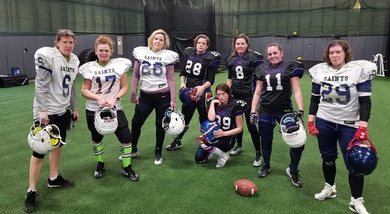 Women's football players post for menacing team photo
