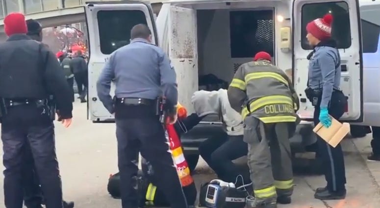 First responders treat a man who was arrested in connection with a police chase before the Kansas City Chiefs Super Bowl victory parade.