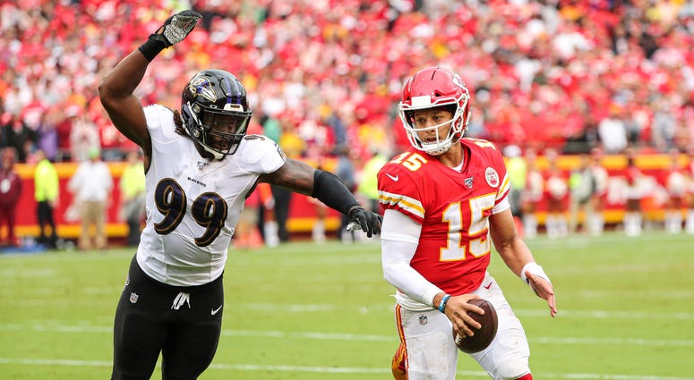 Sep 22, 2019; Kansas City, MO, USA; Kansas City Chiefs quarterback Patrick Mahomes (15) runs against Baltimore Ravens outside linebacker Matt Judon (99) during the second half at Arrowhead Stadium. Mandatory Credit: Jay Biggerstaff-USA TODAY Sports