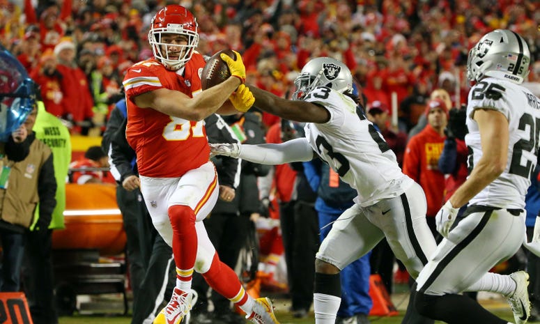 Dec 30, 2018; Kansas City, MO, USA; Kansas City Chiefs tight end Travis Kelce (87) is pushed out of bounds by Oakland Raiders cornerback Nick Nelson (23) in the second half at Arrowhead Stadium. Mandatory Credit: Jay Biggerstaff-USA TODAY Sports