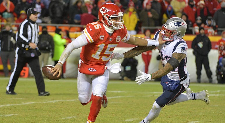 Jan 20, 2019; Kansas City, MO, USA; Kansas City Chiefs quarterback Patrick Mahomes (15) runs with the ball as New England Patriots strong safety Patrick Chung (23) defends during the second half of the AFC Championship game at Arrowhead Stadium. Mandatory