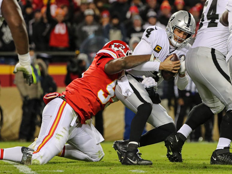 Jay Biggerstaff-USA TODAY Sports Dec 1, 2019; Kansas City, MO, USA; Oakland Raiders quarterback Derek Carr (4) is sacked by Kansas City Chiefs defensive end Chris Jones (95) during the second half at Arrowhead Stadium. Jay Biggerstaff-USA TODAY Sports