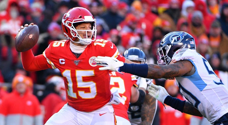 Jan 19, 2020; Kansas City, Missouri, USA; Kansas City Chiefs quarterback Patrick Mahomes (15) throws a pass against Tennessee Titans linebacker Derick Roberson (50) during the first half in the AFC Championship Game at Arrowhead Stadium. Mandatory Credit: