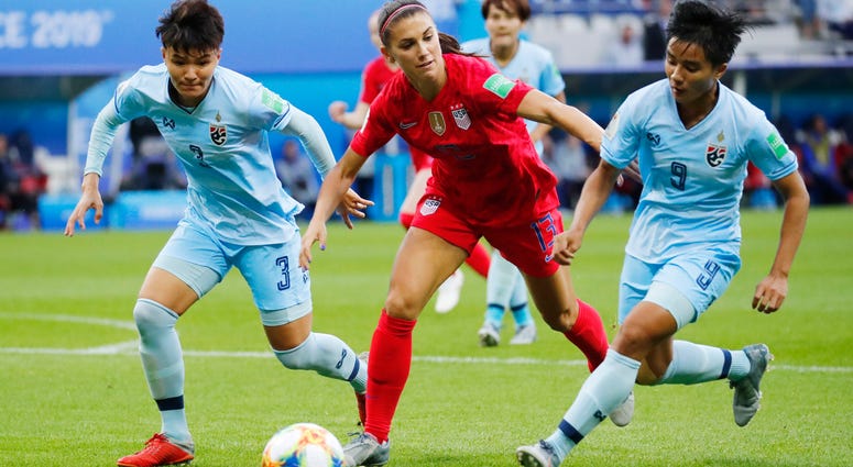 Jun 11, 2019; Reims, FRANCE; United States forward Alex Morgan (13) is defended by Thailand defender Natthakarn Chinwong (3) and defender Warunee Phetwiset (9) during the first half in group stage play during the FIFA Women's World Cup France 2019 at Stad