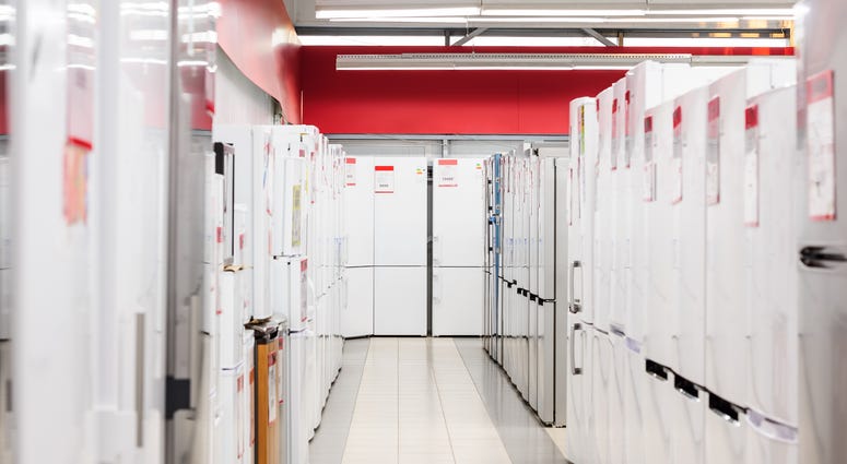 rows of refrigerators in appliance store