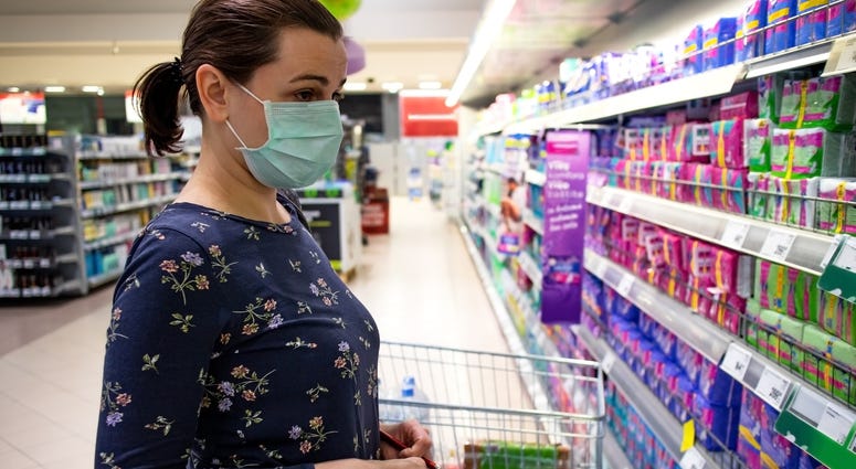 A woman wears a face mask while shopping