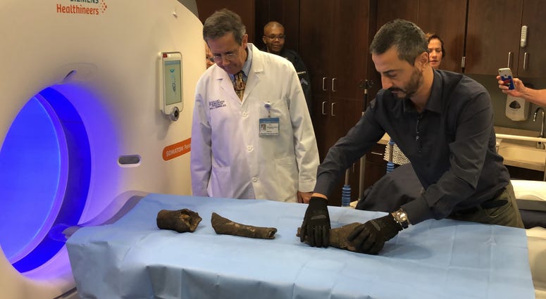 Mummified bones of Queen Nefertari prepare to be scanned by CT.