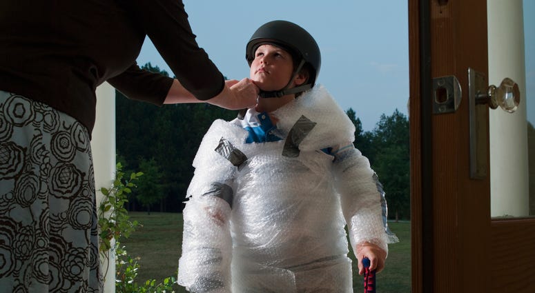 Mother wraps child in bubblewrap to protect him from the world