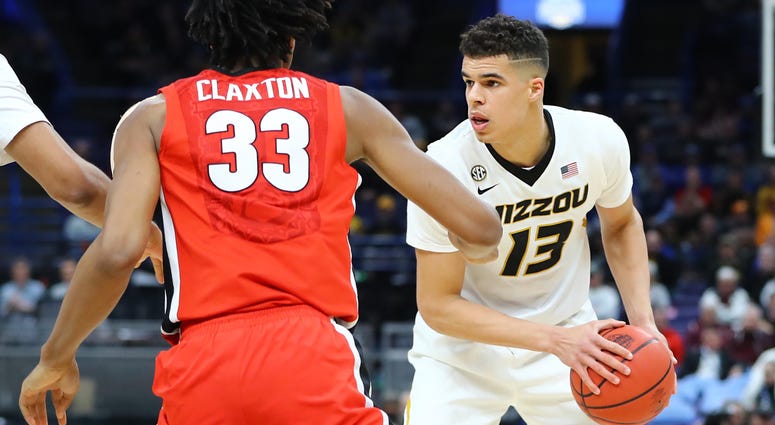 Mar 8, 2018; St. Louis, MO, USA; Missouri Tigers forward Michael Porter Jr. (13) handles the ball as he is defended by Georgia Bulldogs forward Nicolas Claxton (33) during the second half of the second round of the SEC Conference Tournament at Scottrade C