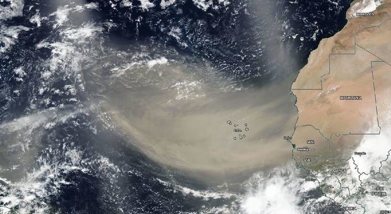 A dust plume seen by satellite moving west off the continent of Africa heading toward North America