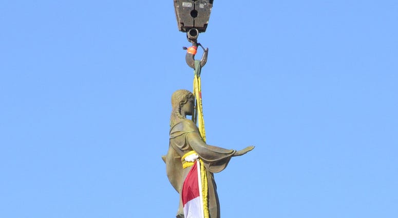 A statue of Ceres, the Roman goddess of agriculture, descends from the top of the Missouri Capitol to the grounds on Nov. 15, 2018. (Photo by Jack Suntrup/St. Louis Post-Dispatch/TNS/Sipa USA)
