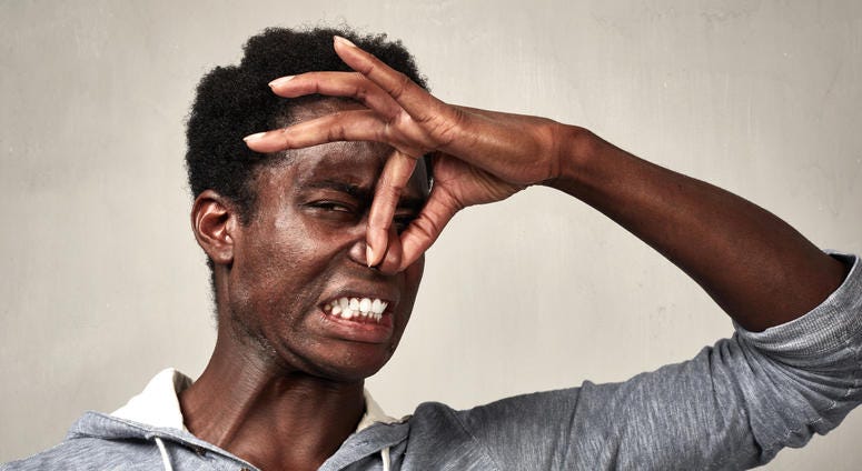 Man holds nose because something smells terrible