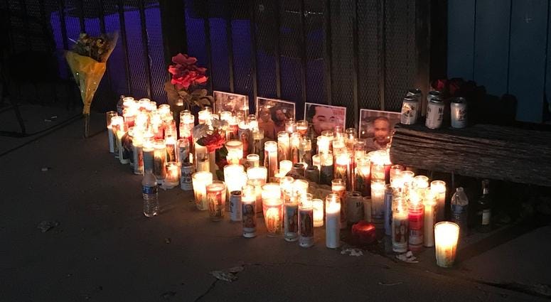 Candles burn outside Tequila KC, where four men were gunned down