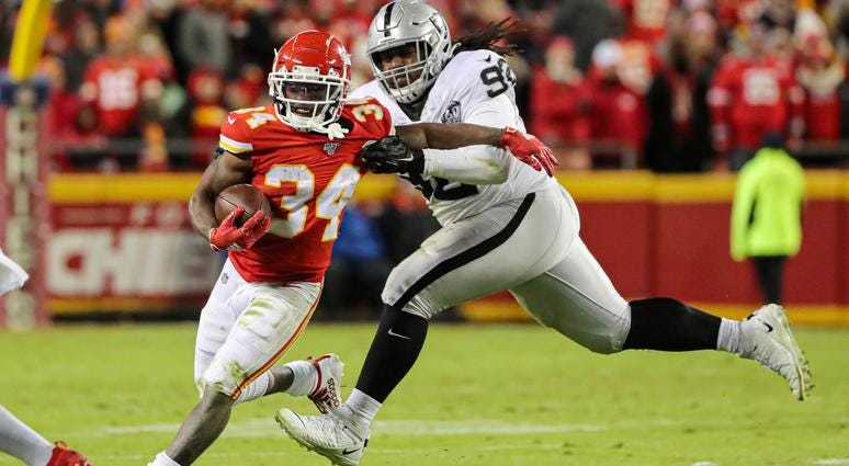 Dec 1, 2019; Kansas City, MO, USA; Kansas City Chiefs running back Darwin Thompson (34) runs against Oakland Raiders defensive tackle P.J. Hall (92) during the second half at Arrowhead Stadium. Jay Biggerstaff-USA TODAY Sports