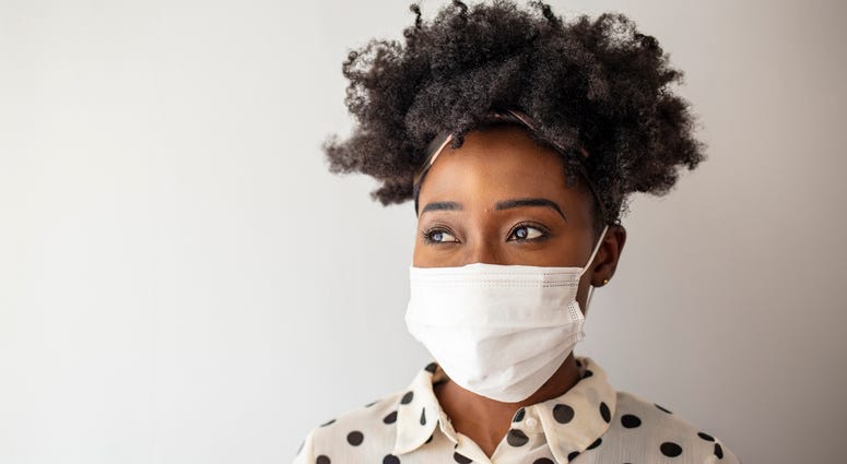 A woman wears a face mask