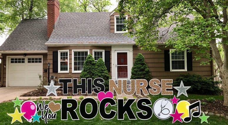 A large yard greeting sign in front of a house in KC