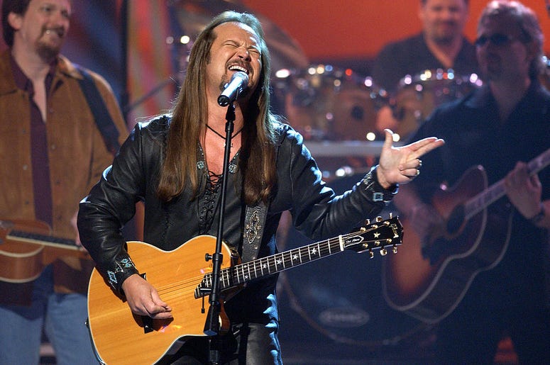 Singer Travis Tritt performs onstage during the 37th Annual Academy of Country Music Awards May 22, 2002 at the Universal Amphitheatre in Los Angeles, CA. Singer Travis Tritt performs onstage during the 37th Annual Academy of Country Music Awards May 22, 2002 at the Universal Amphitheatre in Los Angeles, CA.