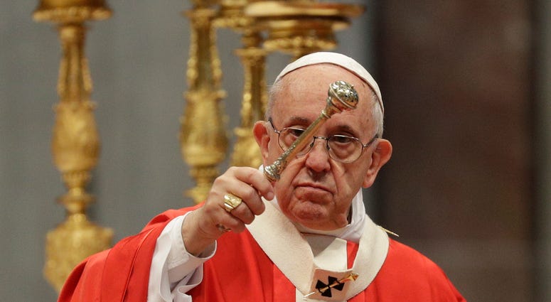 Pope Francis asperges holy water as he celebrates a Pentecost mass in St. Peter's Basilica, at the Vatican, Sunday, May 20, 2018.