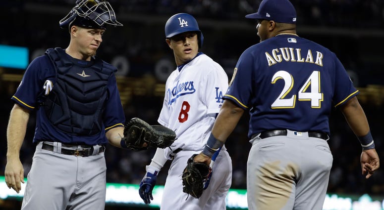 Milwaukee Brewers' Jesus Aguilar and Los Angeles Dodgers' Manny Machado have words Milwaukee Brewers' Jesus Aguilar and Los Angeles Dodgers' Manny Machado have words