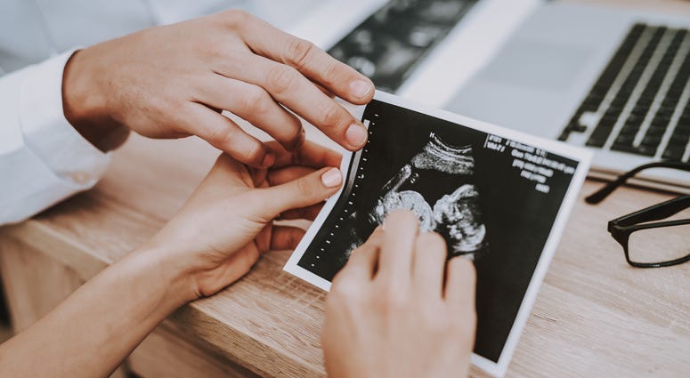 Stock photo of woman looking at ultrasound