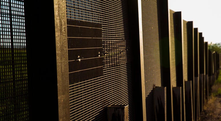 The mesh fence is patched where drug smugglers cut it open and drove a vehicle o The mesh fence is patched where drug smugglers cut it open and drove a vehicle o